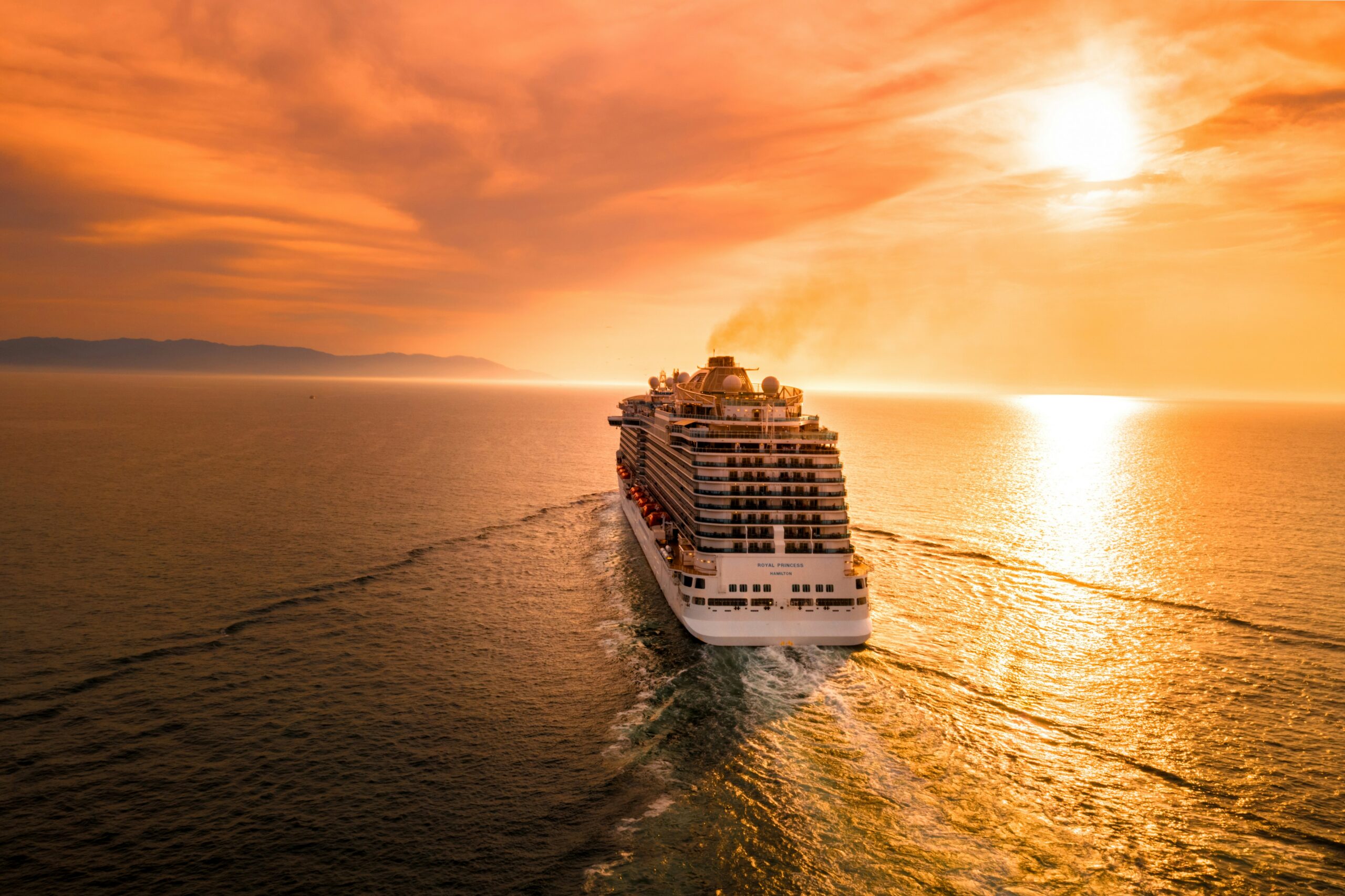 A large modern cruise ship at golden hour