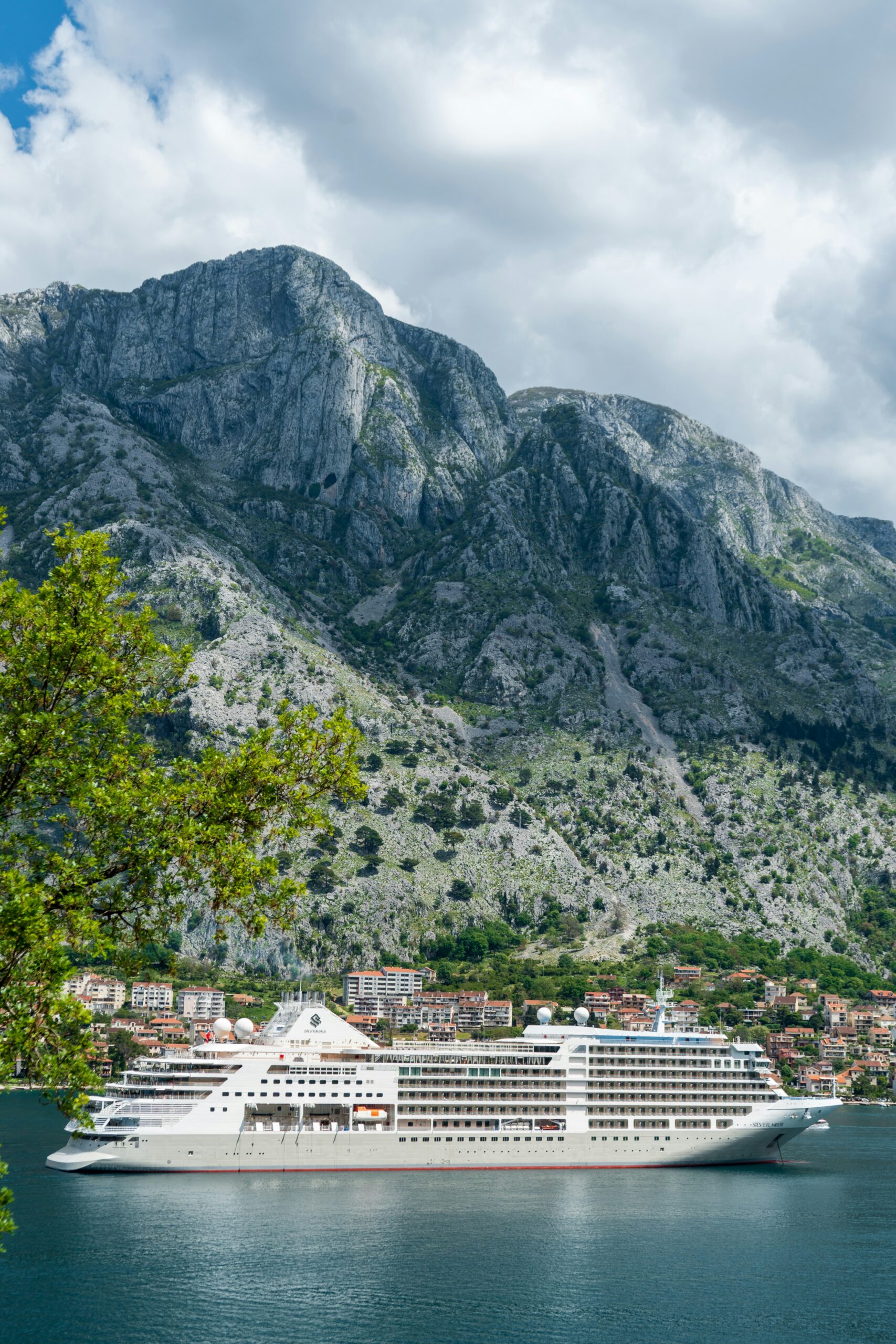 A small boutique ship anchored in a quiet mountain harbor